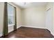 Bright bedroom features wood floors, large window with curtains, and a ceiling fan at 189 Ella Kinley Circle # 201, Myrtle Beach, SC 29588