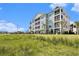 Well-maintained condo building with manicured landscaping, spacious grounds, and screened porches at 189 Ella Kinley Circle # 201, Myrtle Beach, SC 29588