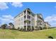 Well-maintained condo building with manicured landscaping, spacious grounds, and screened porches at 189 Ella Kinley Circle # 201, Myrtle Beach, SC 29588