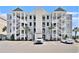 Attractive condo building with multiple floors, exterior staircases, and ample parking at 189 Ella Kinley Circle # 201, Myrtle Beach, SC 29588