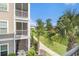 Scenic exterior view from the screened porch overlooking landscaped grounds and palm trees at 189 Ella Kinley Circle # 201, Myrtle Beach, SC 29588