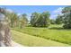 Scenic exterior view from the screened porch overlooking lush landscaped green space and mature trees at 189 Ella Kinley Circle # 201, Myrtle Beach, SC 29588