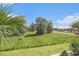 Scenic exterior view from the screened porch overlooking lush landscaped green space and mature trees at 189 Ella Kinley Circle # 201, Myrtle Beach, SC 29588