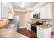 Modern kitchen featuring stainless steel appliances, granite countertops, and classic white cabinetry at 189 Ella Kinley Circle # 201, Myrtle Beach, SC 29588