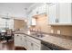 Bright kitchen with stainless steel sink, granite countertops, and white cabinets with black hardware at 189 Ella Kinley Circle # 201, Myrtle Beach, SC 29588