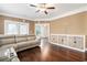 Bright living room with hardwood floors, a ceiling fan, and a leather sectional sofa at 189 Ella Kinley Circle # 201, Myrtle Beach, SC 29588