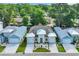 An aerial view of a home with a landscaped yard, three-car garage, and symmetrical design at 1936 Indigo Cove Ln, Calabash, NC 28467