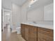 Bright bathroom featuring wood cabinetry, a white countertop, and a framed mirror at 1936 Indigo Cove Ln, Calabash, NC 28467