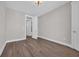 Empty bedroom with wood-look flooring and modern light at 1936 Indigo Cove Ln, Calabash, NC 28467