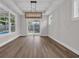 Bright dining room features wood floors and an elegant chandelier at 1936 Indigo Cove Ln, Calabash, NC 28467
