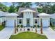 Stunning home with a well-manicured lawn, a two-car garage and charming light-green shutters at 1936 Indigo Cove Ln, Calabash, NC 28467