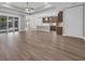 Open-concept living space featuring sleek wood flooring, recessed lighting, and a view to the pool at 1936 Indigo Cove Ln, Calabash, NC 28467