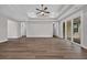 Open-concept living space featuring sleek wood flooring, recessed lighting, and multiple doorways at 1936 Indigo Cove Ln, Calabash, NC 28467