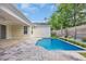 Sparkling pool featuring a brick surround, lawn, and tall wooden fence at 1936 Indigo Cove Ln, Calabash, NC 28467