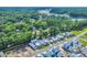 An aerial view showcases the property's location amidst lush green surroundings, highlighting its proximity to the water and community at 1940 Indigo Cove Ln, Calabash, NC 28467