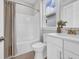 Bright bathroom featuring a shower-tub combo, white vanity, and modern fixtures at 1940 Indigo Cove Ln, Calabash, NC 28467