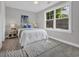 Comfortable bedroom featuring a large window, soft carpet, and neutral decor at 1940 Indigo Cove Ln, Calabash, NC 28467