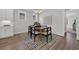 Bright dining room featuring a modern chandelier, wood floors, and a stylish area rug at 1940 Indigo Cove Ln, Calabash, NC 28467