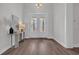 Elegant foyer with hardwood floors, white trim, stylish lighting, and French doors at 1940 Indigo Cove Ln, Calabash, NC 28467