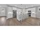 Modern kitchen with white cabinets, stainless steel appliances, and a center island with bar seating at 1940 Indigo Cove Ln, Calabash, NC 28467