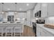 Well-lit kitchen features white cabinets, stainless steel appliances, and a stylish backsplash at 1940 Indigo Cove Ln, Calabash, NC 28467