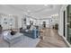 Bright open-concept living room seamlessly connects the living, dining, and kitchen areas, promoting a sense of togetherness at 1940 Indigo Cove Ln, Calabash, NC 28467