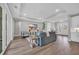 Open concept living room with tray ceilings, modern furniture, and luxury vinyl flooring at 1940 Indigo Cove Ln, Calabash, NC 28467