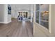 Inviting living room with wood floors, a comfortable blue sofa, and views of the outdoor patio at 1940 Indigo Cove Ln, Calabash, NC 28467