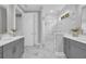 Elegant main bathroom featuring double vanity, frameless glass shower, and modern fixtures at 1940 Indigo Cove Ln, Calabash, NC 28467