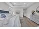 Serene main bedroom featuring tray ceiling, wood floors, and access to an ensuite bath at 1940 Indigo Cove Ln, Calabash, NC 28467