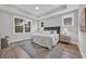 Relaxing main bedroom with tray ceiling, large windows, and an area rug at 1940 Indigo Cove Ln, Calabash, NC 28467
