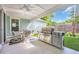 Covered patio with an outdoor kitchen and stainless steel grill at 1940 Indigo Cove Ln, Calabash, NC 28467