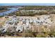 This is an aerial view of a neighborhood with a beautiful river and lake nearby at 1946 Indigo Cove Ln, Calabash, NC 28467