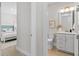 This bathroom features a toilet, vanity, drawers, mirror and lighting fixtures at 1946 Indigo Cove Ln, Calabash, NC 28467