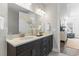 Bathroom featuring double sinks, a stylish vanity, and natural light from a nearby room at 1946 Indigo Cove Ln, Calabash, NC 28467
