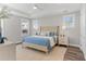 Serene bedroom with hardwood floors, tray ceilings, and plenty of natural light at 1946 Indigo Cove Ln, Calabash, NC 28467