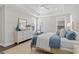 Bright bedroom with tray ceilings, area rug, stylish dresser, and comfortable chair at 1946 Indigo Cove Ln, Calabash, NC 28467