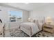 Well-lit bedroom with a comfortable bed, side tables, and a large window with blinds at 1946 Indigo Cove Ln, Calabash, NC 28467