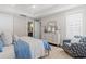 Comfortable bedroom with neutral decor, hardwood floors, and ensuite bathroom at 1946 Indigo Cove Ln, Calabash, NC 28467