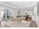 Bright dining area featuring modern lighting, adjacent to an open-concept kitchen at 1946 Indigo Cove Ln, Calabash, NC 28467