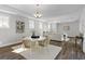 Open-concept dining area connects the kitchen and living room, bathed in natural light at 1946 Indigo Cove Ln, Calabash, NC 28467