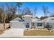 Charming coastal home featuring a two-car garage and beautifully landscaped front yard at 1946 Indigo Cove Ln, Calabash, NC 28467