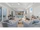 Bright living room boasts tray ceiling, hardwood floors, and seamless open-concept layout at 1946 Indigo Cove Ln, Calabash, NC 28467