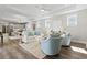 Open-concept living room showcases hardwood floors, natural light, and stylish, neutral decor at 1946 Indigo Cove Ln, Calabash, NC 28467