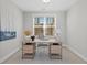 This bright office space includes a desk, chair, modern decor, and natural light at 1946 Indigo Cove Ln, Calabash, NC 28467