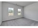 A bright bedroom offers natural light from two windows and has neutral carpet and paint at 200 Lister St, Conway, SC 29526