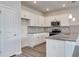 Modern kitchen with white cabinetry, stainless steel appliances, and an island with bar seating at 200 Lister St, Conway, SC 29526