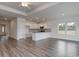 Open-concept living area with hardwood floors, a kitchen with an island, and lots of natural light at 200 Lister St, Conway, SC 29526