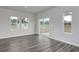 Spacious living room with ample natural light, sleek hard floors, and multiple windows with views at 200 Lister St, Conway, SC 29526