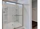 Modern bathroom with large glass shower, integrated shelving and a walk-in closet at 200 Lister St, Conway, SC 29526